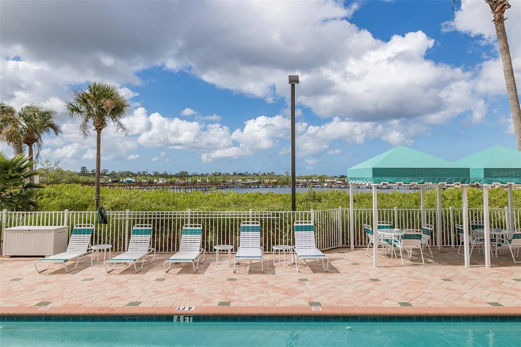 4516 Seagull Drive, Unit 411 New Port Richey, FL 34652 - Photo 31 of 47 a view of a lake with a sitting area