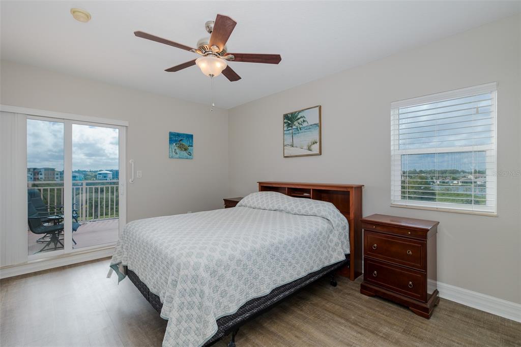 4516 Seagull Drive, Unit 411 New Port Richey, FL 34652 - Photo 4 of 47 a bedroom with a bed and a large window