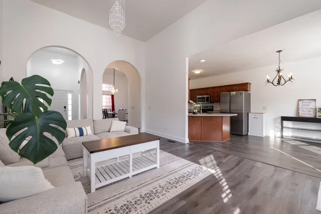 a open kitchen with stainless steel appliances granite countertop a stove and a refrigerator