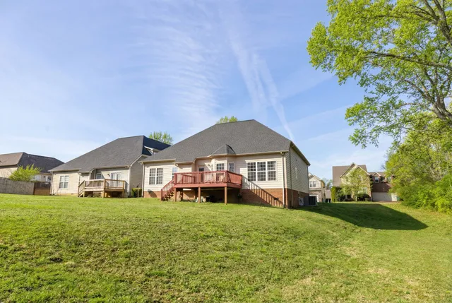 a front view of a house with a garden and trees