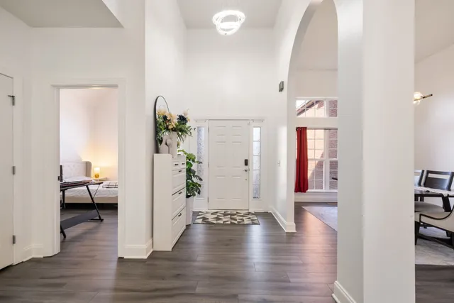 a view of a livingroom with furniture hardwood floor and hallway