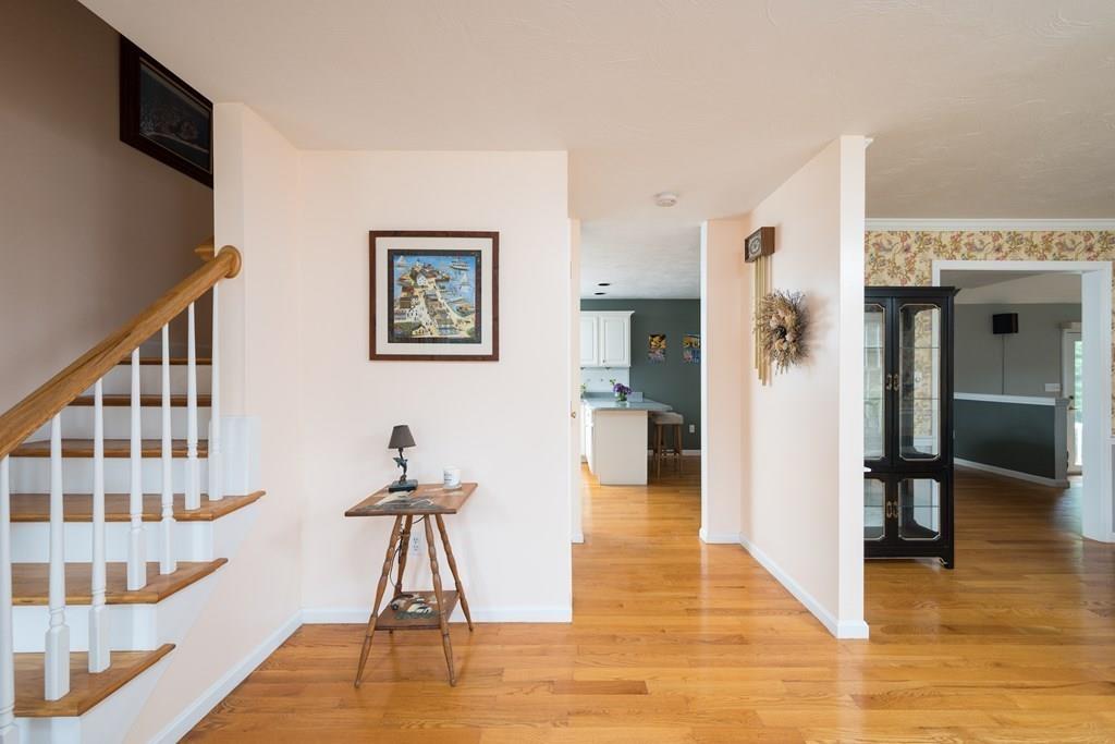 3 Tupelo Drive Hingham, MA 02043 - Photo 19 of 35 a view of a hallway with wooden floor and staircase