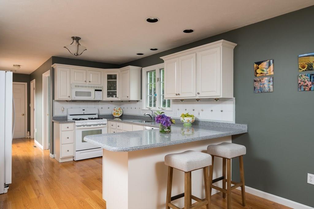 3 Tupelo Drive Hingham, MA 02043 - Photo 4 of 35 a kitchen with kitchen island granite countertop a sink cabinets and wooden floor