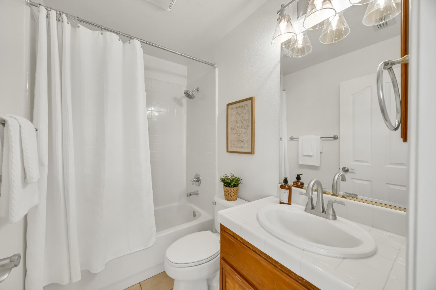 6041 Lockridge Drive Granite Bay, CA 95746 - Photo 30 of 67 a bathroom with a sink a toilet and shower curtain