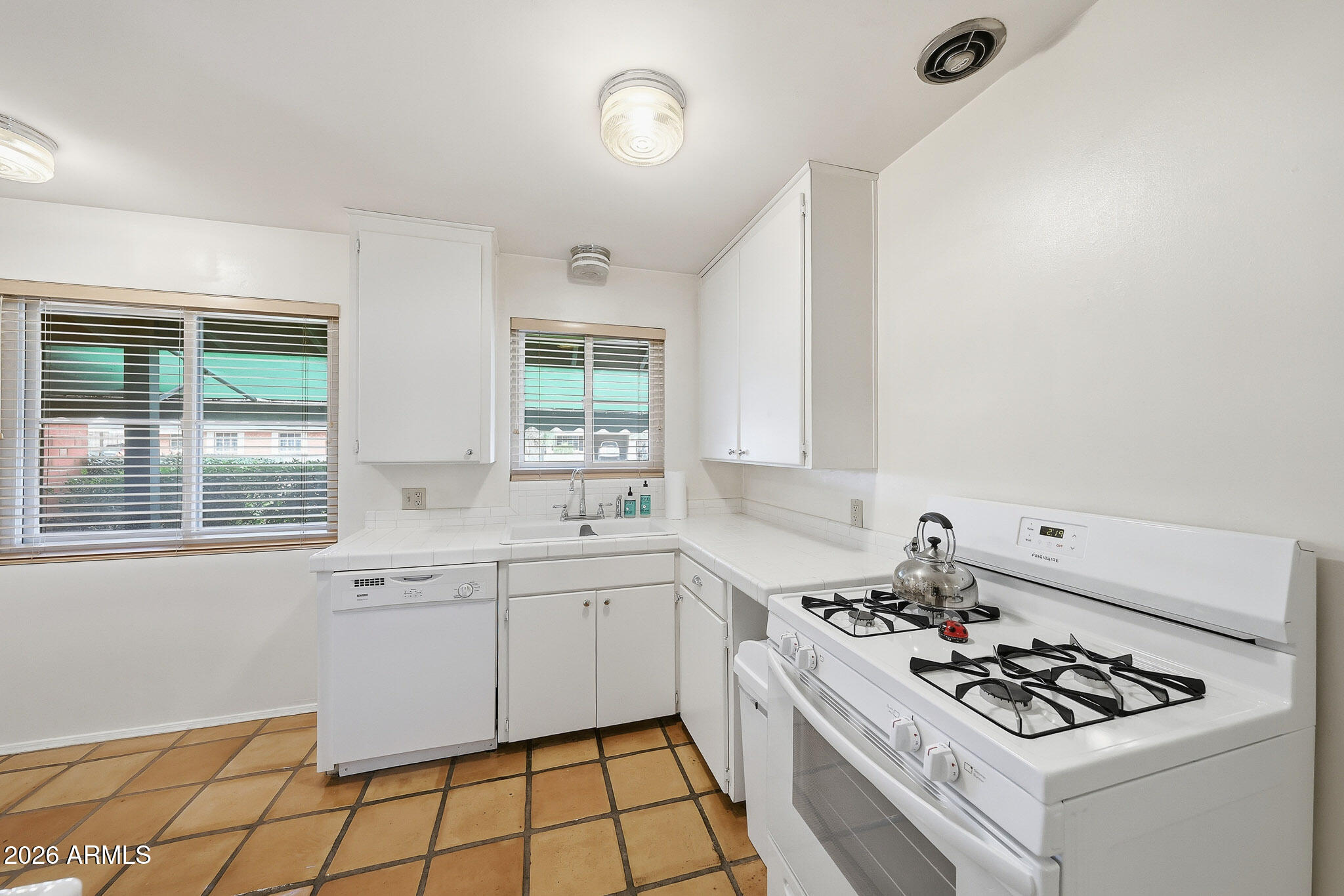 2215 West Earll Drive Phoenix, AZ 85015 - Photo 13 of 55 a kitchen that has a sink and a stove