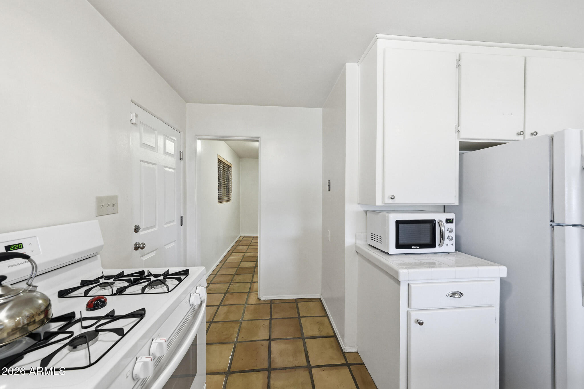2215 West Earll Drive Phoenix, AZ 85015 - Photo 15 of 55 a kitchen with sink a stove and refrigerator