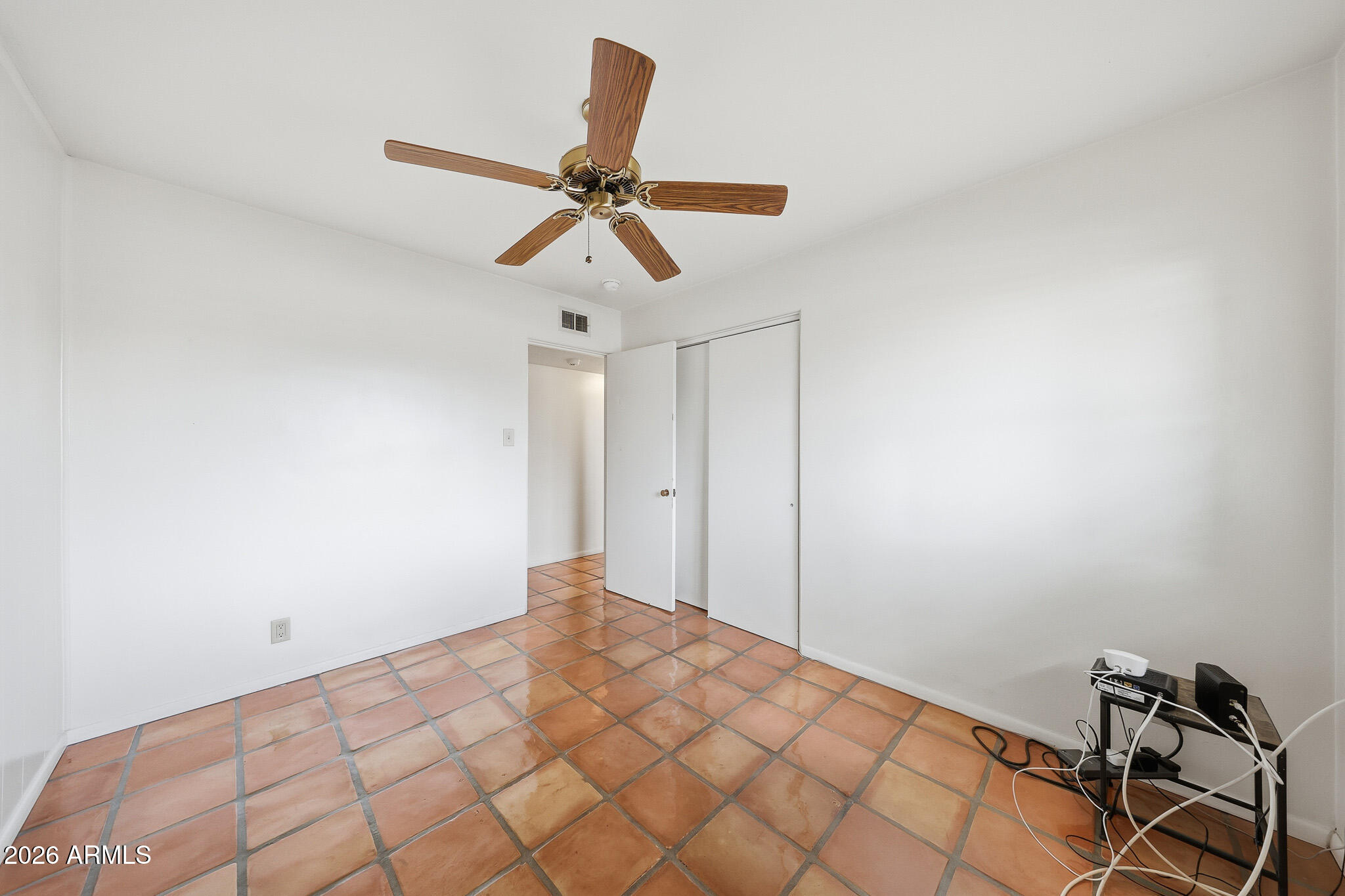 2215 West Earll Drive Phoenix, AZ 85015 - Photo 18 of 55 a bedroom with a bed and a chandelier fan
