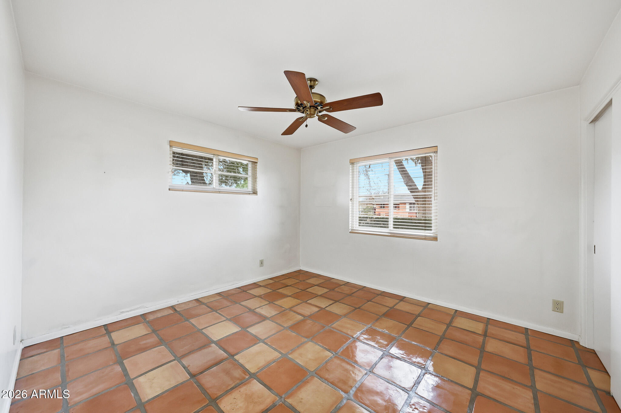 2215 West Earll Drive Phoenix, AZ 85015 - Photo 19 of 55 a view of a big room with wooden floor and a ceiling fan