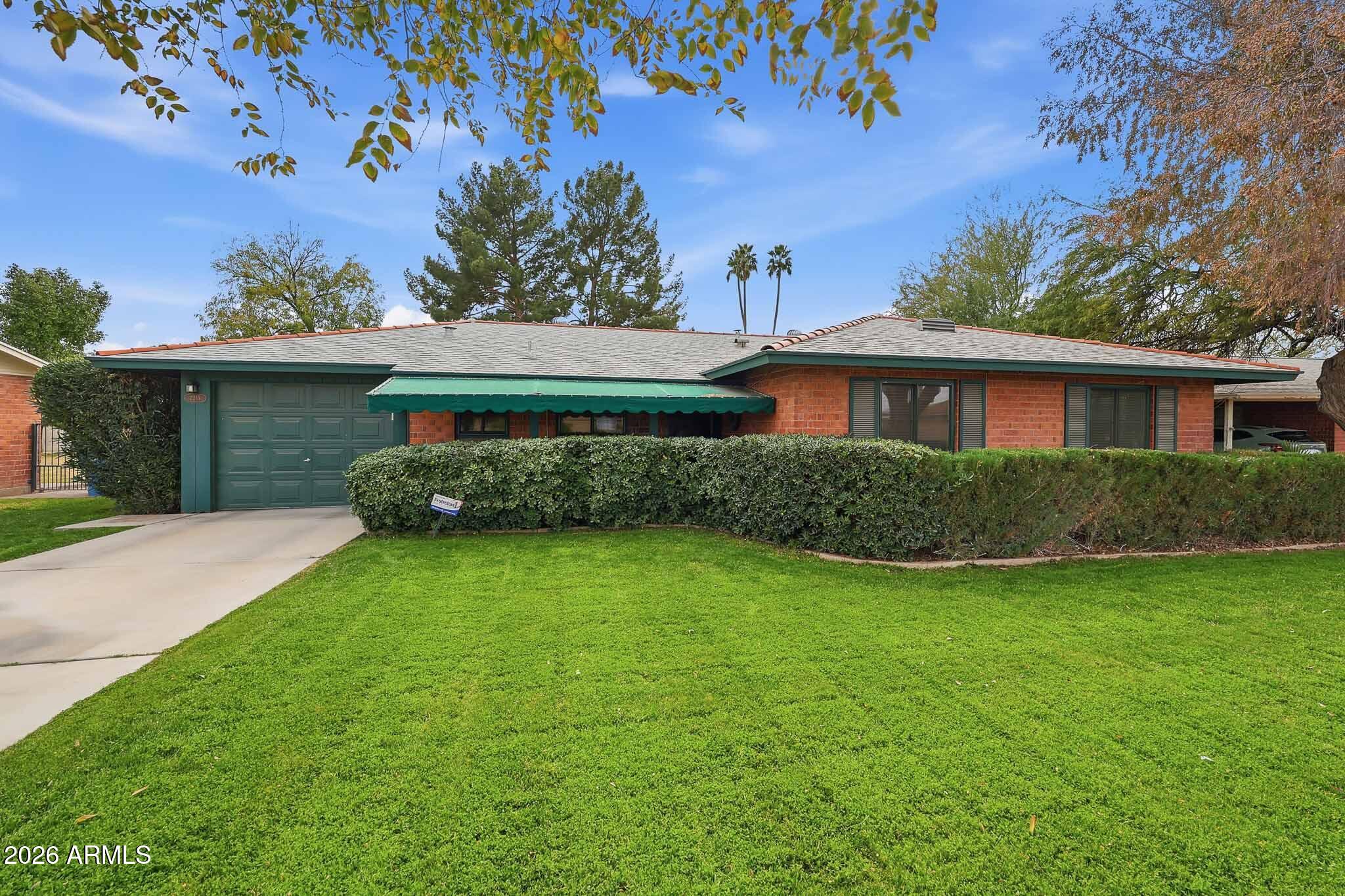2215 West Earll Drive Phoenix, AZ 85015 - Photo 3 of 55 a front view of a house with a garden