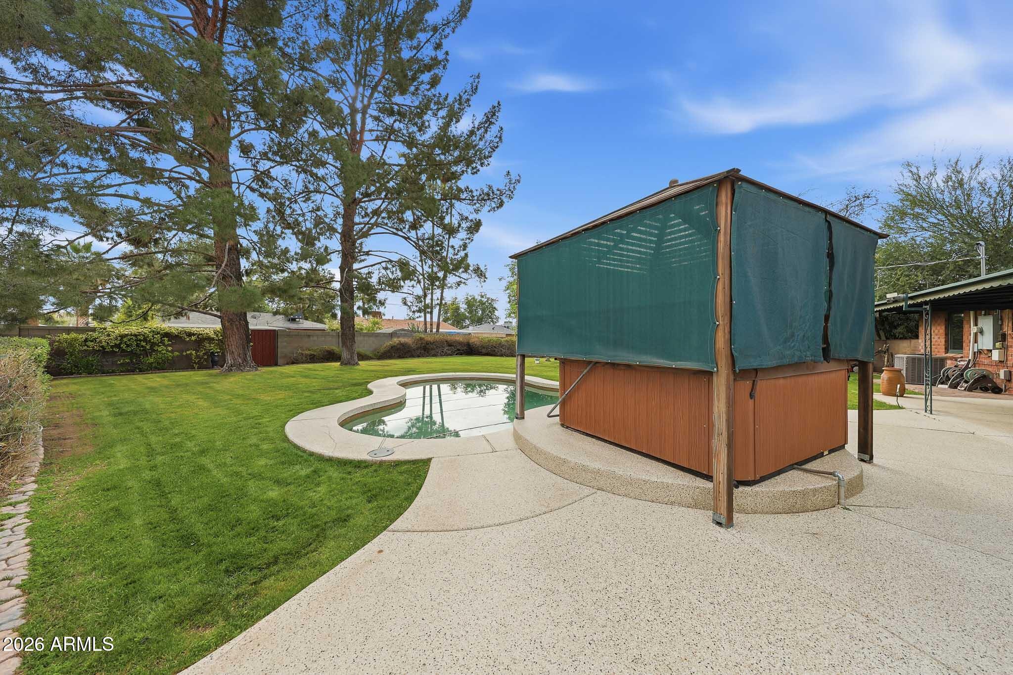2215 West Earll Drive Phoenix, AZ 85015 - Photo 36 of 55 a view of a backyard with a tub and trees