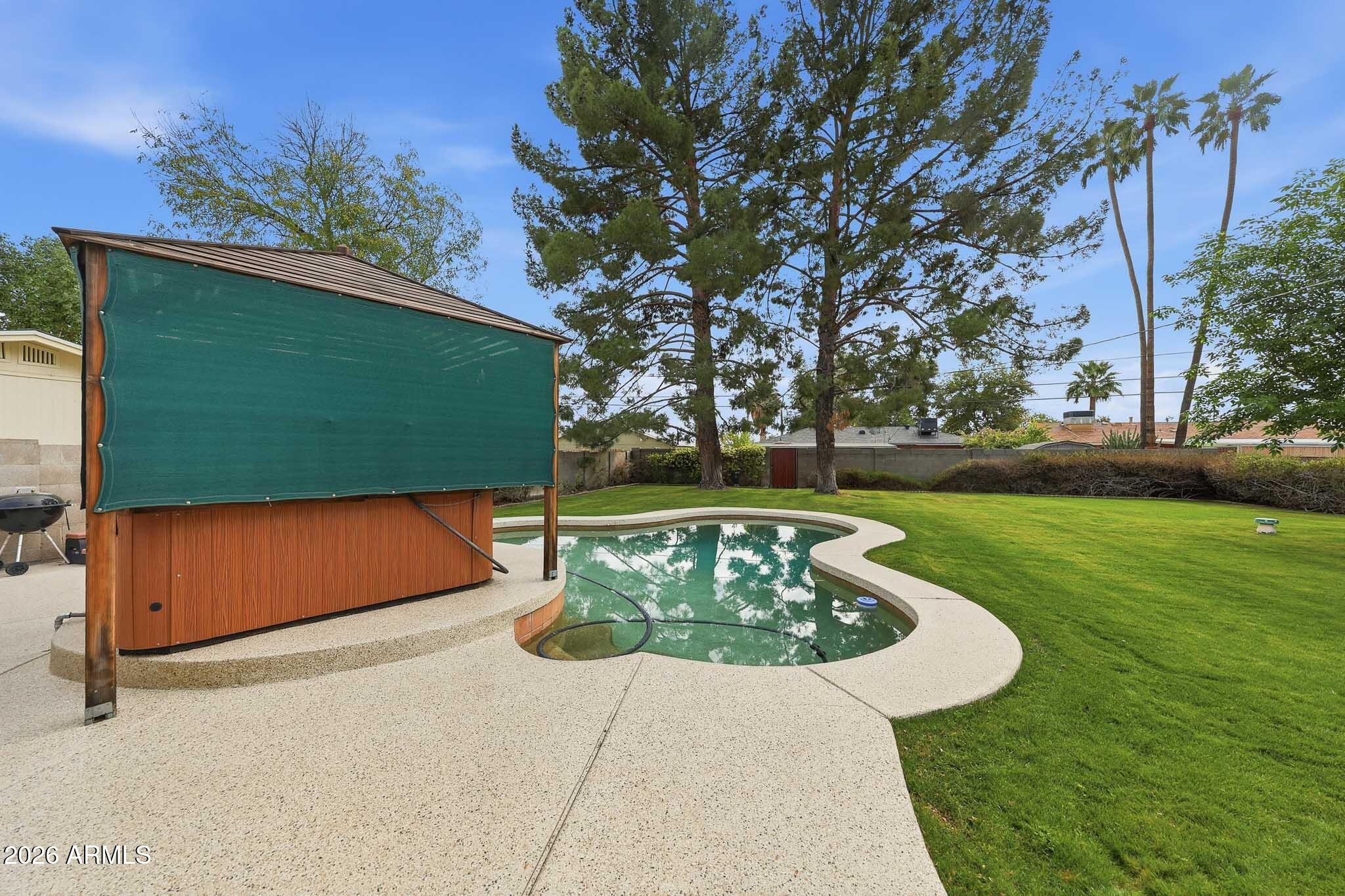 2215 West Earll Drive Phoenix, AZ 85015 - Photo 38 of 55 a view of a garden with a bench