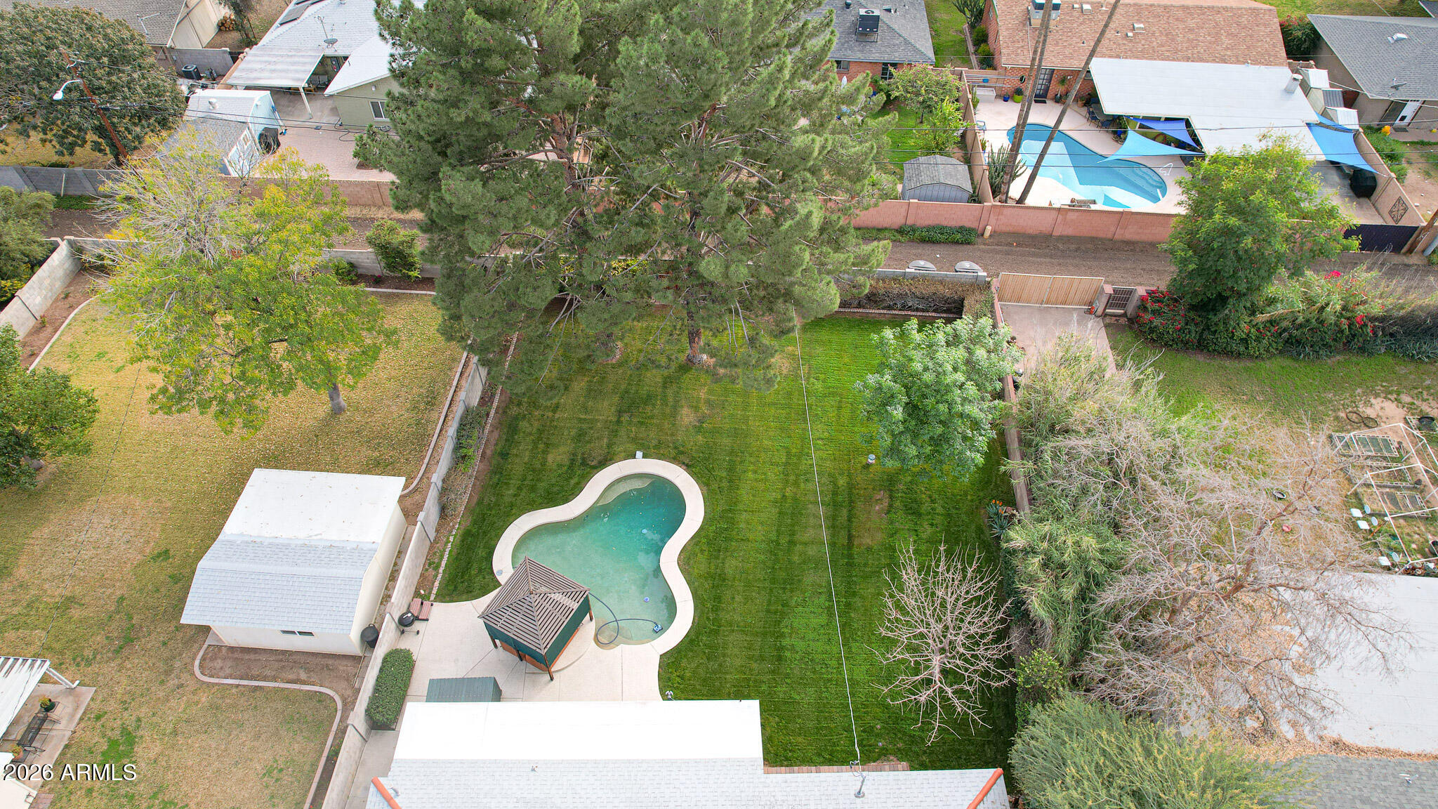 2215 West Earll Drive Phoenix, AZ 85015 - Photo 46 of 55 an aerial view of a house with swimming pool and large trees