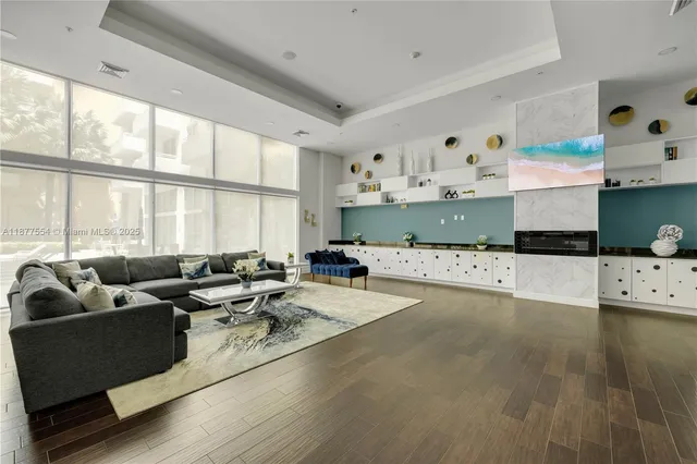 a living room with furniture and large windows