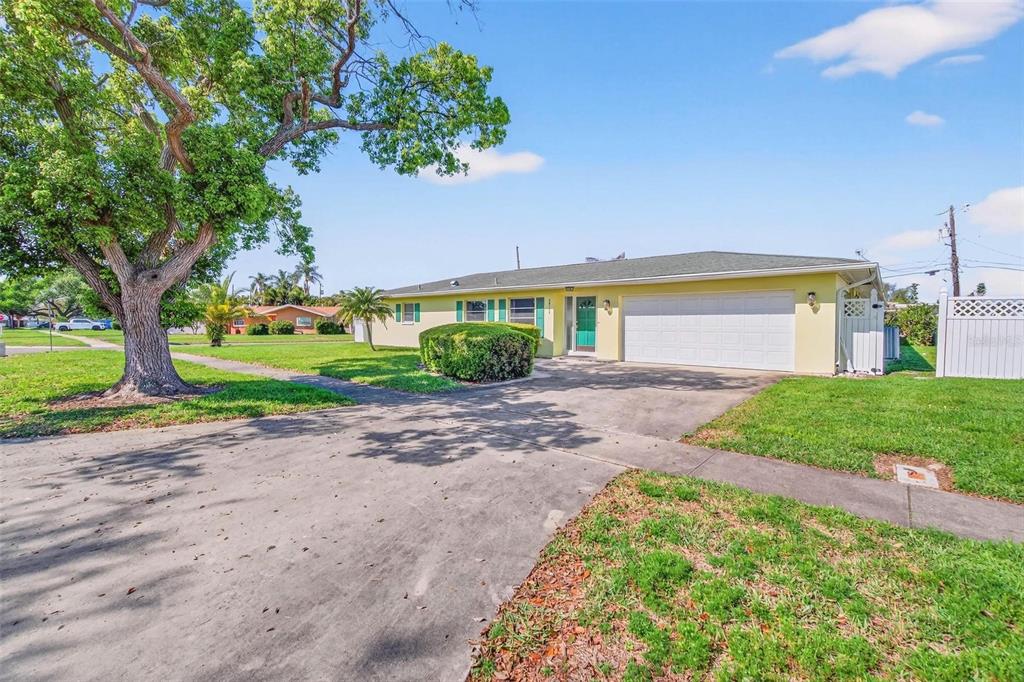 10100 Commodore Drive Seminole, FL 33776 - Photo 1 of 43 a view of a house with a yard