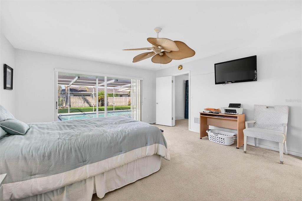 10100 Commodore Drive Seminole, FL 33776 - Photo 15 of 43 a bedroom with a bed and a flat screen tv