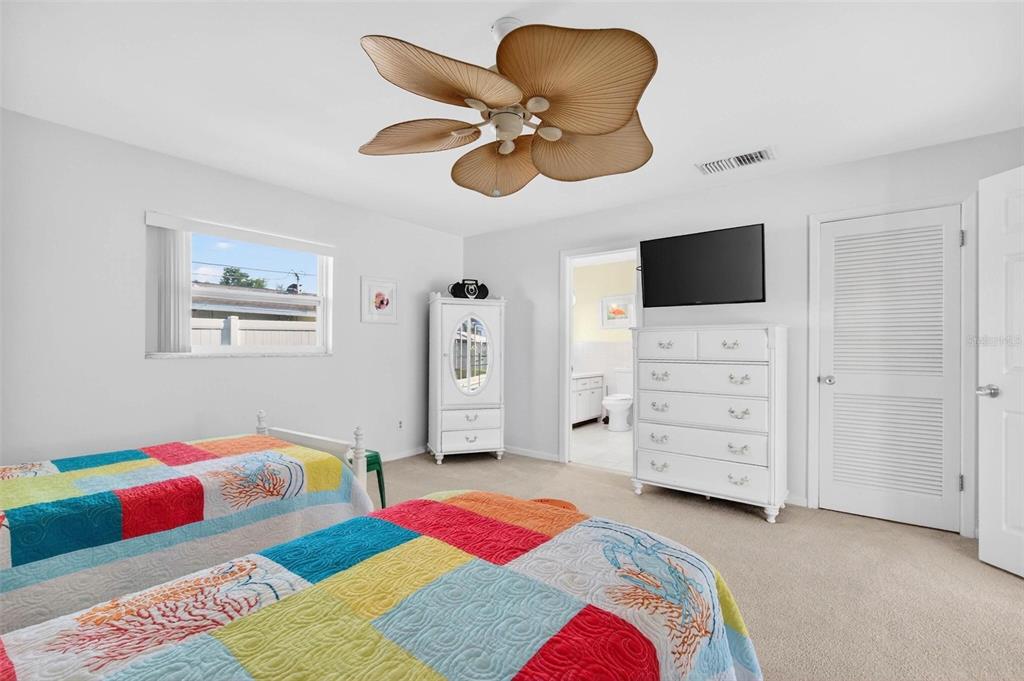 10100 Commodore Drive Seminole, FL 33776 - Photo 23 of 43 a bedroom with a bed and a television