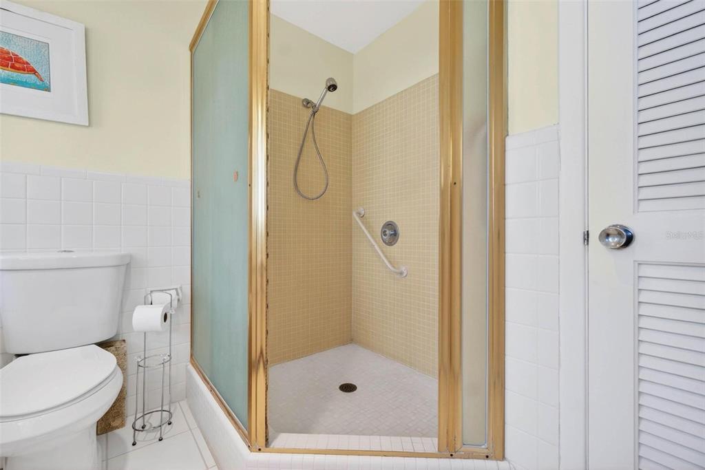 10100 Commodore Drive Seminole, FL 33776 - Photo 25 of 43 a bathroom with a shower and a toilet