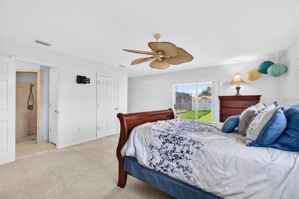 10100 Commodore Drive Seminole, FL 33776 - Photo 29 of 43 a bedroom with a bed and ceiling fan