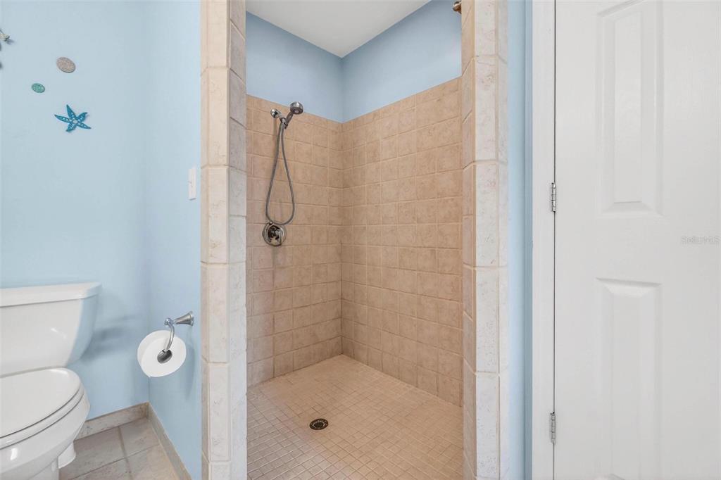 10100 Commodore Drive Seminole, FL 33776 - Photo 31 of 43 a bathroom with a shower and a toilet