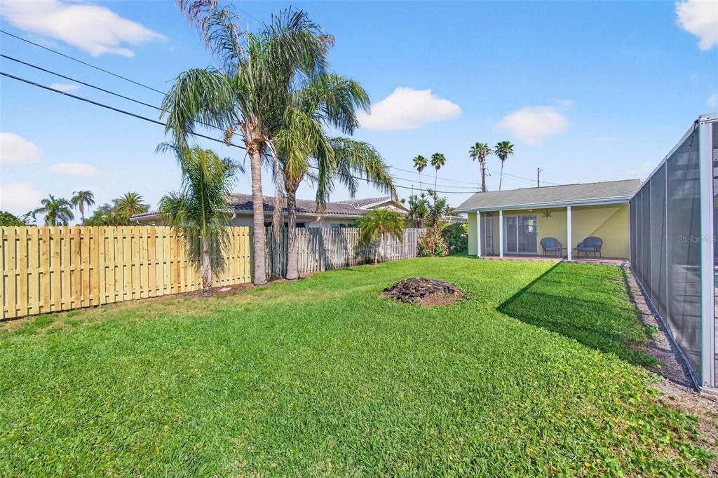 10100 Commodore Drive Seminole, FL 33776 - Photo 38 of 43 a view of a house with a yard and plants