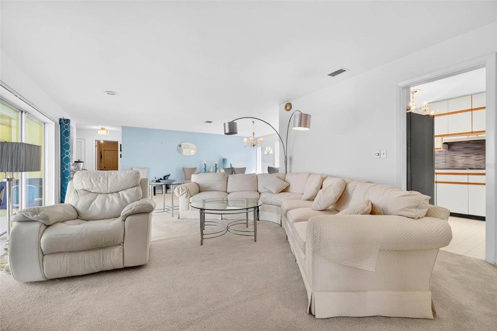 10100 Commodore Drive Seminole, FL 33776 - Photo 8 of 43 a living room with furniture and a large window