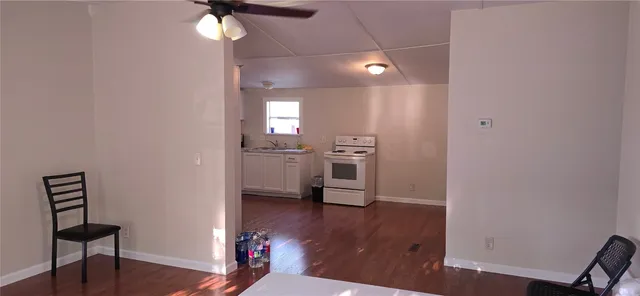 a view of a hallway with wooden floor and workspace