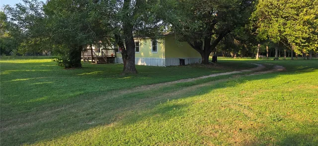 a view of a trees in front of a house