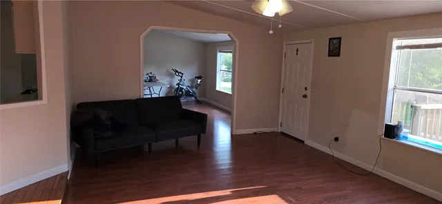 a living room with furniture and a wooden floor