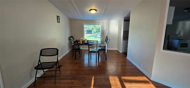 a view of a livingroom with furniture and a window