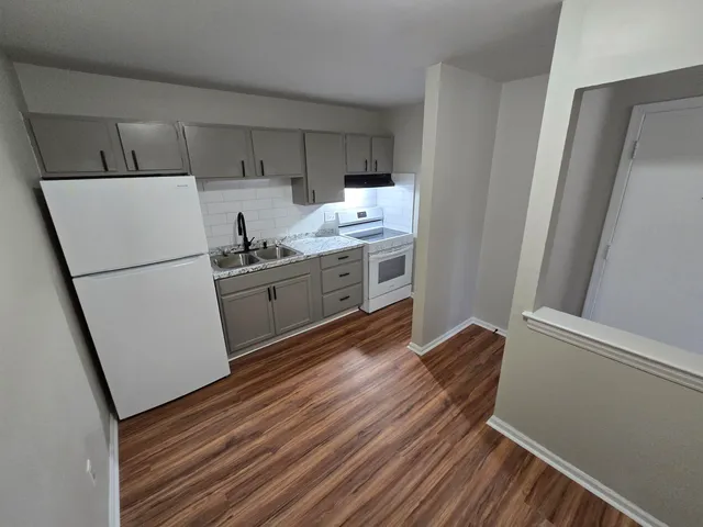a kitchen with a refrigerator and a sink