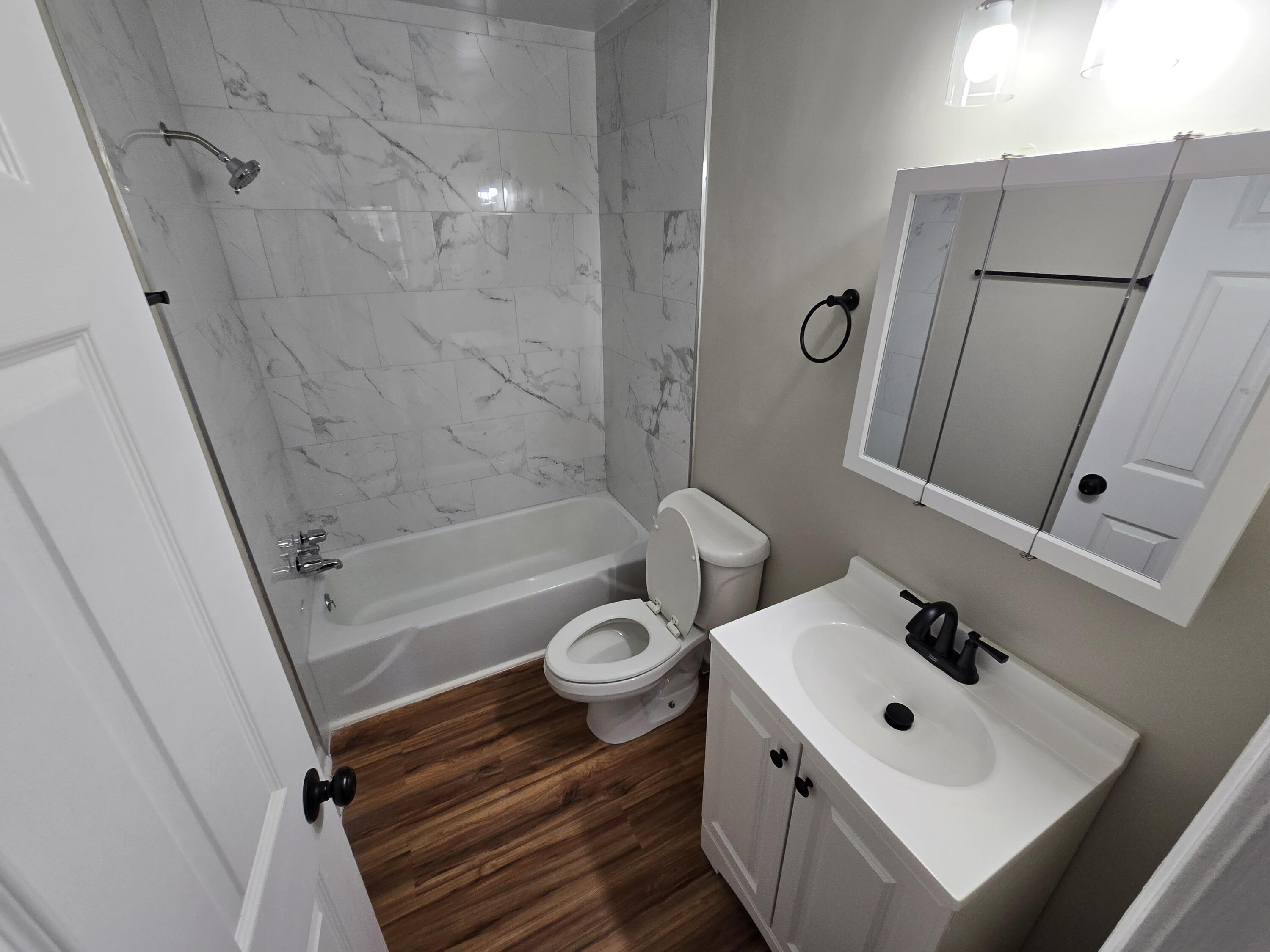 2626 Westover Avenue Southwest, Unit 7 Roanoke, VA 24015 - Photo 5 of 7 a bathroom with a sink toilet and shower