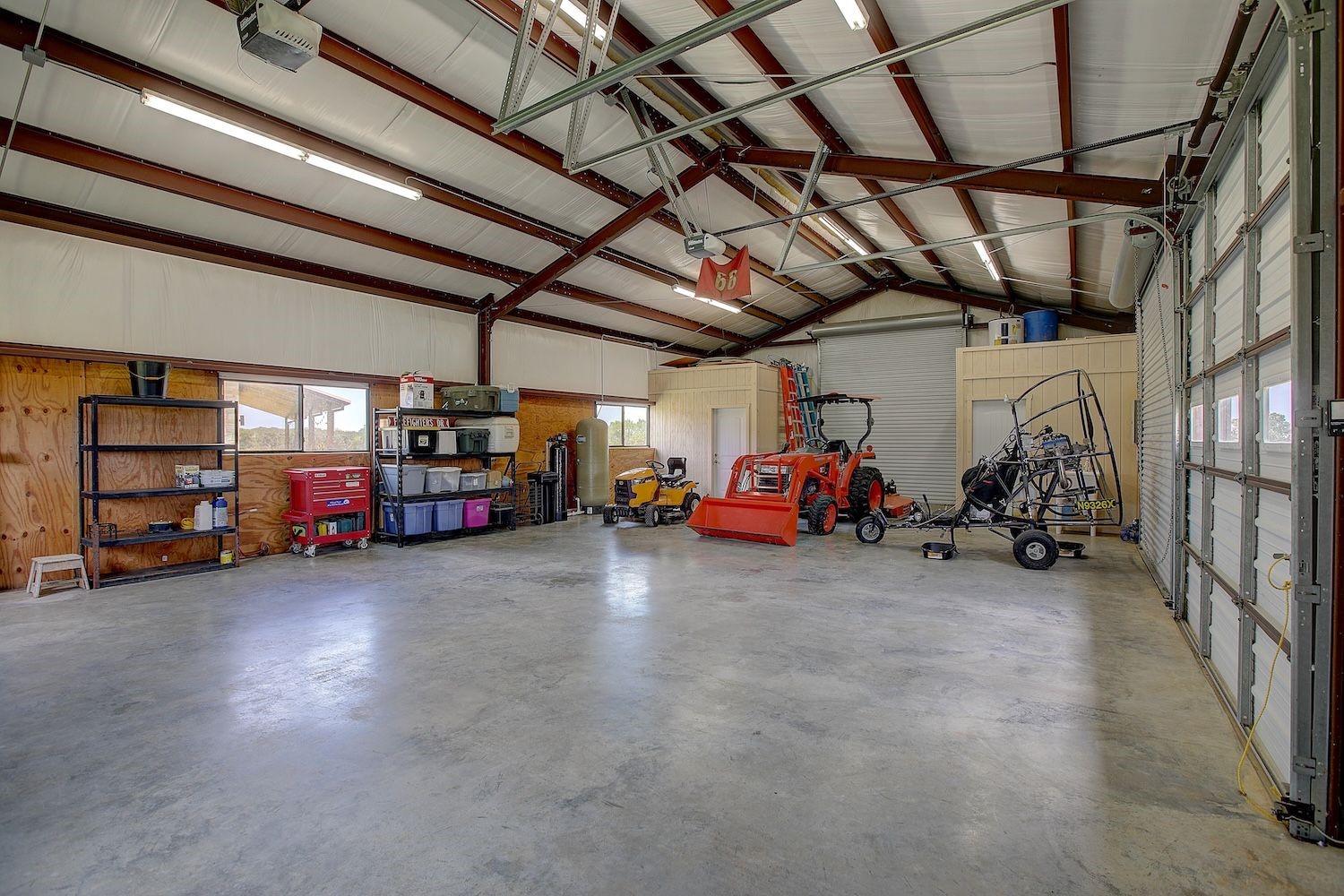 9414 Laird Road Round Top, TX 78954 - Photo 12 of 50 Interior of the garage/workshop with loads of storage and toys