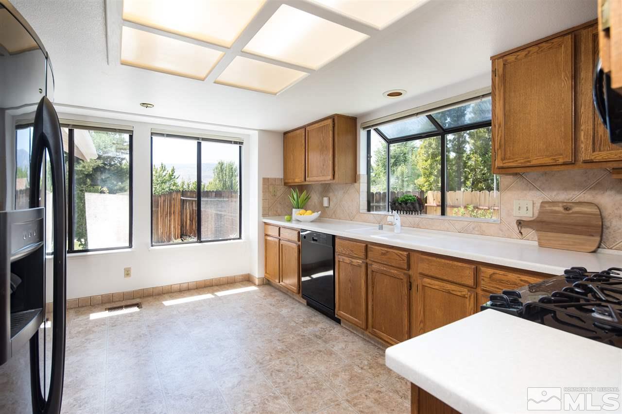 5310 Vista Ridge Way Reno, NV 89523 - Photo 8 of 25 a kitchen with stainless steel appliances a sink window and cabinets