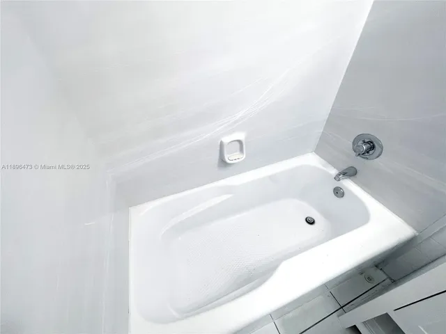a bath tub sitting next to a white sink