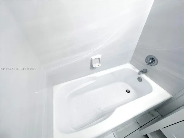 a bath tub sitting next to a white sink