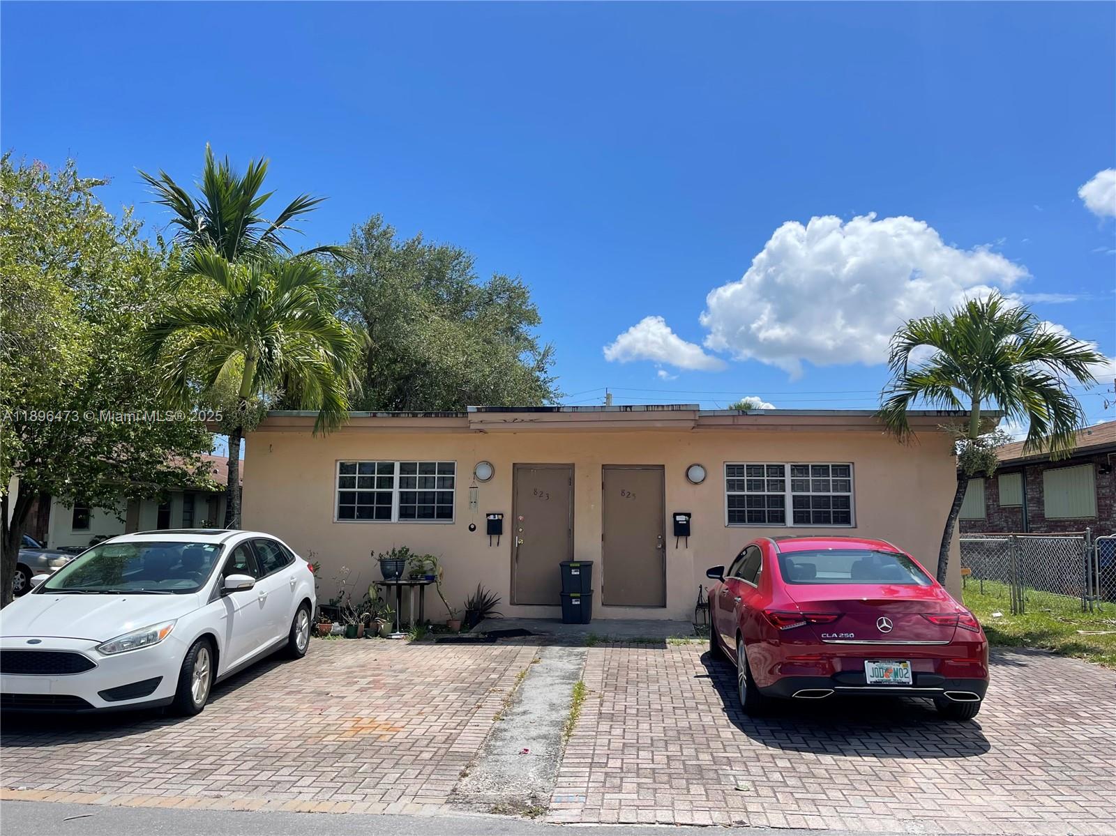 825 Northwest 9th Street, Unit 825 Hallandale Beach, FL 33009 - Photo 2 of 18 a front view of a house with parking space