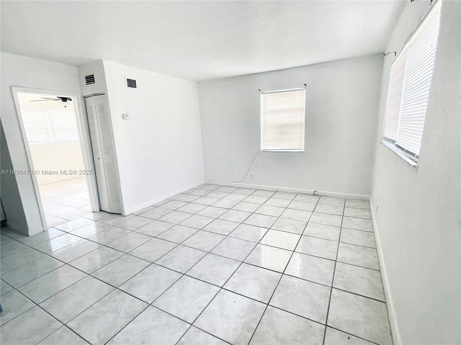 825 Northwest 9th Street, Unit 825 Hallandale Beach, FL 33009 - Photo 4 of 18 a view of an empty room and window
