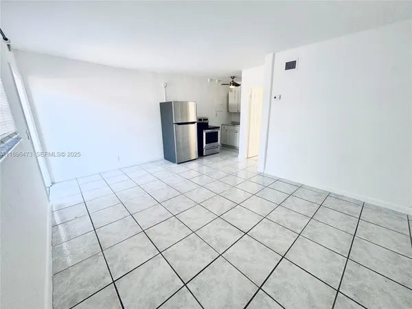 a view of a refrigerator and window in a room