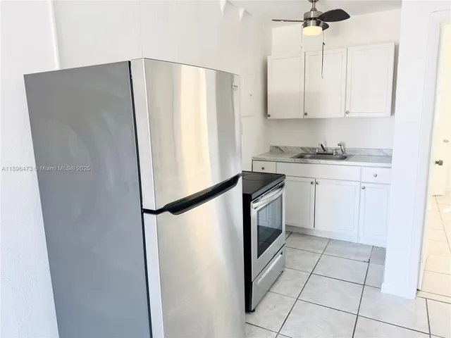 a white refrigerator freezer sitting inside of a kitchen