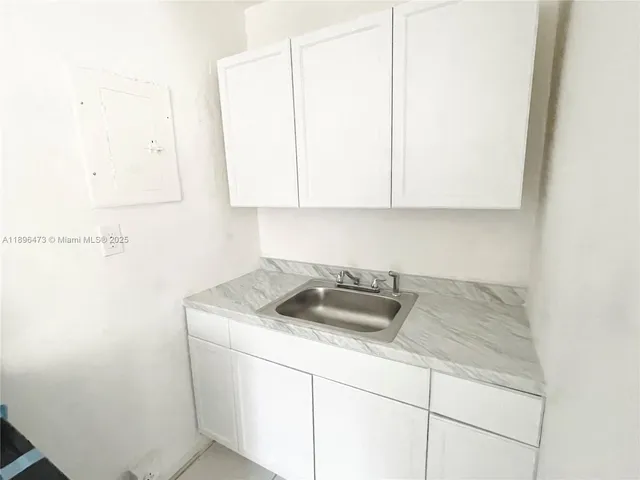 a kitchen with a sink and cabinets