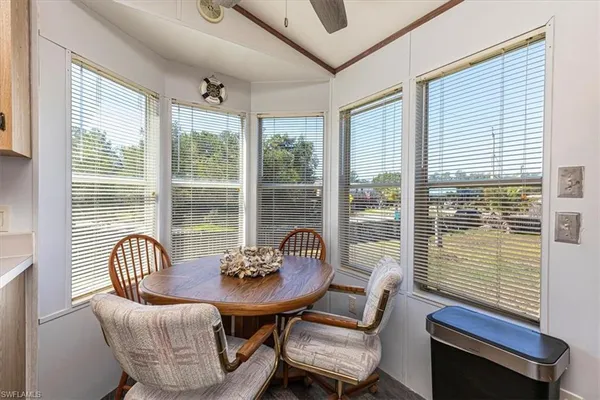a living room with stainless steel appliances furniture a fireplace and a flat screen tv