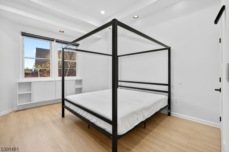 159 Palisade Avenue, Unit 2R Jersey City, NJ 07306 - Photo 16 of 26 a view of a room with furniture and windows