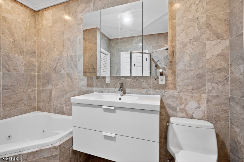 159 Palisade Avenue, Unit 2R Jersey City, NJ 07306 - Photo 24 of 26 a bathroom with a sink toilet and shower