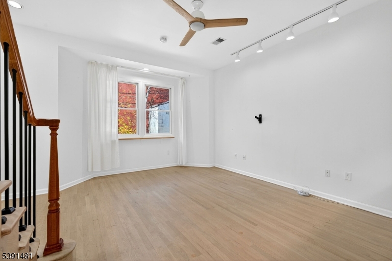 159 Palisade Avenue, Unit 2R Jersey City, NJ 07306 - Photo 4 of 26 wooden floor in an empty room with a window