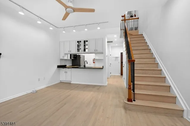a view of a kitchen with a sink and a refrigerator