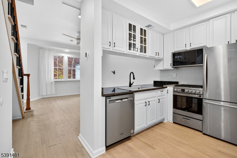 159 Palisade Avenue, Unit 2R Jersey City, NJ 07306 - Photo 10 of 26 a kitchen with stainless steel appliances a stove sink and refrigerator