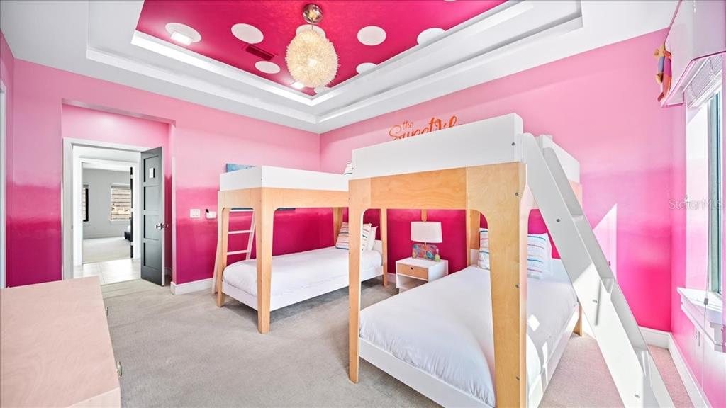 331 Muirfield Loop Reunion, FL 34747 - Photo 23 of 100 a bedroom with pink walls and pink walls