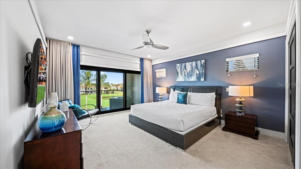 331 Muirfield Loop Reunion, FL 34747 - Photo 56 of 100 a spacious bedroom with a bed and a large window