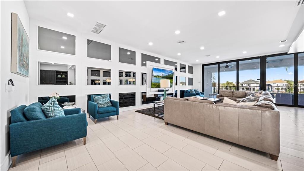 331 Muirfield Loop Reunion, FL 34747 - Photo 69 of 100 a living room with furniture and a large window
