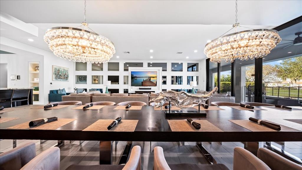 331 Muirfield Loop Reunion, FL 34747 - Photo 77 of 100 a view of a dining room with furniture a chandelier and kitchen view